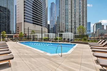 the pool on the rooftop of a building with skyscrapers in the background  at Cassidy on Canal, Chicago